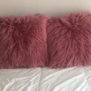 TWO furry throw pillows